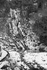 Fototapeta na wymiar Waterfall in a snowy landscape