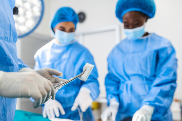 Doctor and assistant nurse operating for help patient from dangerous emergency case .Surgical instruments on the sterile table in the emergency operation room in the hospital.Health care and Medical