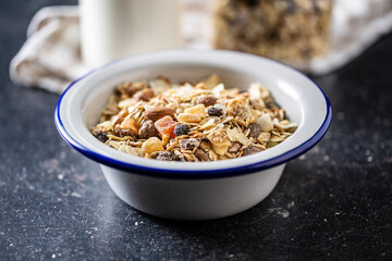 Beakfast cereals in bowl. Healthy muesli with oat flakes, nuts and raisins