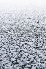 Selective focus. Smooth transition of asphalt from dark to light. Direct linear perspective. Sharpness is in the center of the image.