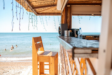 An empty bar counter and an empty chair against the background of the beach and the sea. Vacation...