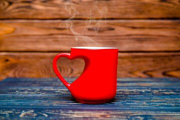 heart shaped mugs with tea on brown background