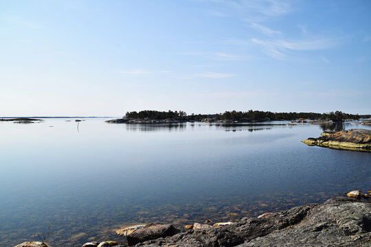 Tranquil sunny day in the Swedish archipelago. Calm water and no people around. Photo taken in the archipelago outside Oskarshamn in Sweden.