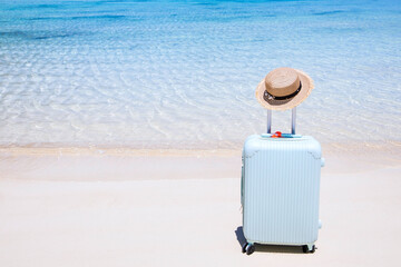 Summer vacation with blue luggage and Travel in a Sand Beach Island