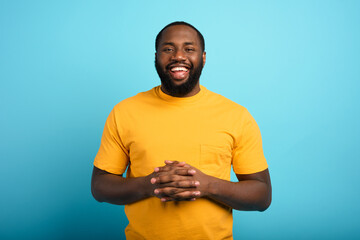 Joyful and happy man over cyan background