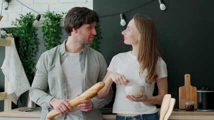 Romantic young couple cooking together in the kitchen,having a great time together