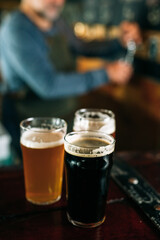 middle aged man bartender serving beer in beer pub