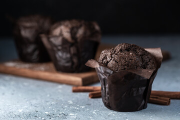 Chocolate muffins with crispy top. Selective focus. Copy space.