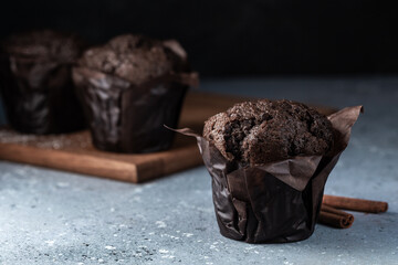 Chocolate muffins with crispy top. Selective focus. Copy space.