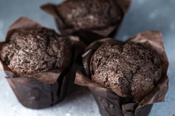 Chocolate muffins with crispy top. Selective focus. Copy space.
