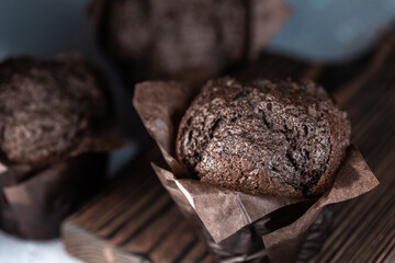 Chocolate muffins with crispy top. Selective focus. Copy space.