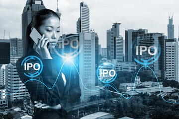 Attractive Asian businesswoman in suit conducting conference call to set up effectively IPO to...