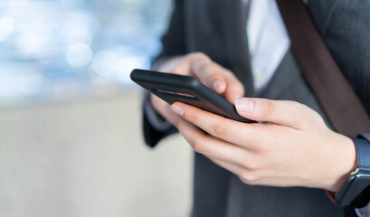 close up businessman hand hold smartphone and touchscreen on digital display to working by use internet 4G cellular network for business and technology concept