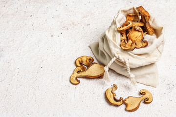 Forest dried edible mushrooms in a linen sack