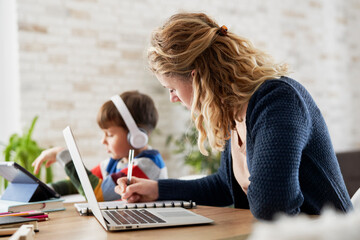 Mother during home office and son during homeschooling