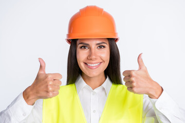 Photo of adviser lady look camera raise two thumbs up wear helmet shirt vest isolated white color background