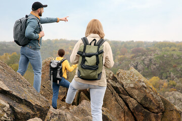 Group of hikers with backpacks at top of mountain