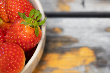 Berries of fresh juicy strawberries on wooden background