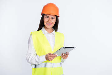 Photo of positive foreman lady hold tablet toothy smile wear helmet shirt vest isolated white color background