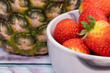Berries of fresh juicy strawberries on wooden background