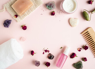 Composition from various cosmetics and minerals on pink background.