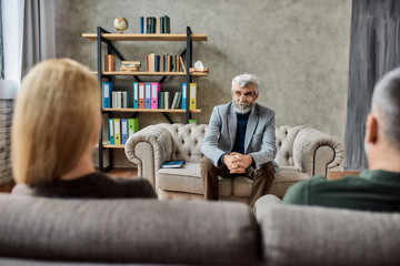 Professional psychotherapist listening to upset couple