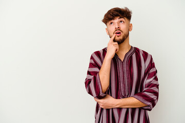 Young Moroccan man isolated on white background looking sideways with doubtful and skeptical expression.