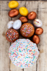 Painted eggs and iced cake on   wooden background