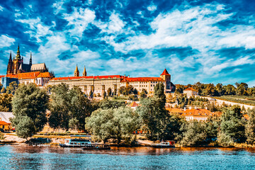 Obraz premium View of Prague Castle from waterfront- famous historic bridge that crosses the Vltava river in Prague, Czech Republic.