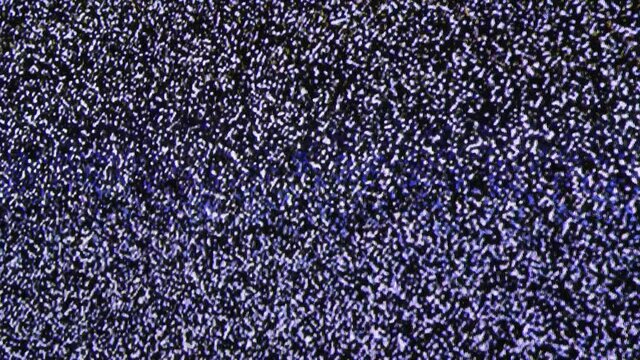 Close up view at a plasma tv while showing white noise activity.