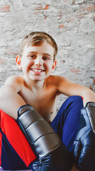  Portrait of young Shirtless boy boxer with blonde hair wearing boxing gloves workout at home 
