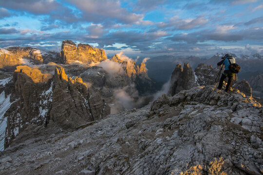 Photographer in Dolomites mountains