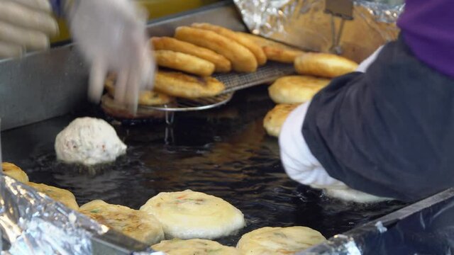 Frying Filled Dough In A Griddle With Oil. Cooking Hotteok, Korean Pancake, And Popular Street Food In South Korea. close up