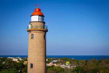 Fototapeta premium View of lighthouse from near by rock in Mahabalipuram, Tamil Nadu, India. Mahabalipuram is a town near Chennai famous for rock monuments and is a world heritage site