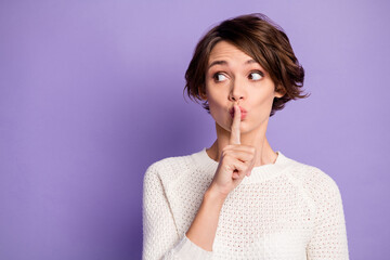 Photo of adorable charming young woman finger lips ask no talks looking empty space isolated purple color background