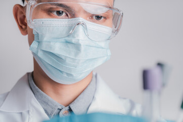 Doctors wear a surgical mask and glasses, Scientists, Scientists hold syringes and vaccines for COVID-19., vaccination and laboratory experiments. Virus protection concept COVID-19,