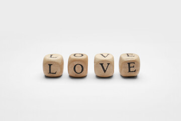 Mini cubes with letters forming word Love on white background