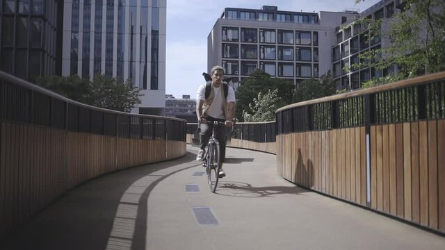 man cycling on public bridge in the city, 50 fps conformed to 25 fps.