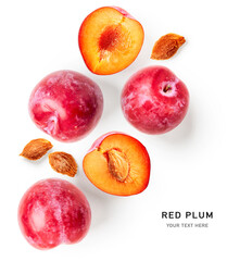 Red plum fruits and stones creative layout.