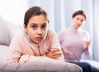 Young mother reprimands her daughter for wrong acts and bad behavior