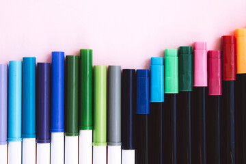 Fototapeta premium Colorful marker pen set on pink background. Background with copy space. Flat lay