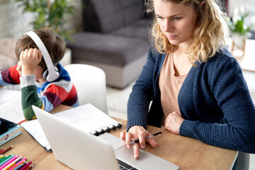 Mother working while her son is home schooling