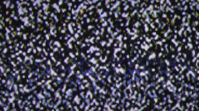 Close up view at a plasma tv while showing white noise activity.