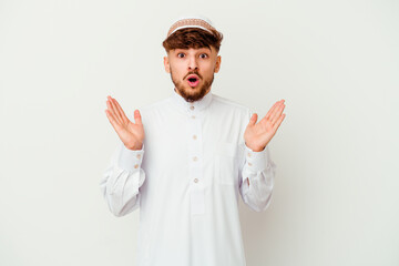 Young Arab man wearing the typical arabic costume isolated on white background surprised and shocked.