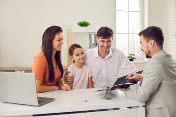 Happy family with daughter sitting and looking at contract points in hands of real estate agent feeling happy and positive with making deal about relocating. Renting buying moving to new accomodation