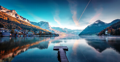 Amazing autumn scene of Grundlsee lake. Austria. Colorful morning view of calm alpine lake with colorful sky over the mountains. Iconic location for landscape photographers and blogers. Creative image