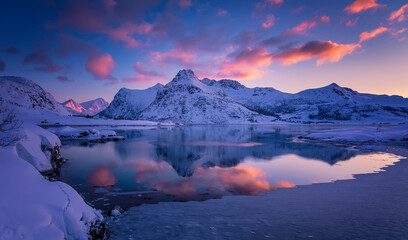 Fototapeta na wymiar Wonderful winter nature scenery. Stunning image north fjord with snowcapped mountains and colorful sky during sunset. Popular locations of northern Norway. Amazing Lofoten islands. nature background.