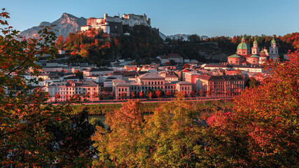 Fototapeta premium Incredible view of the historic city of Salzburg with famous Hohensalzburg Fortress and fortification tower in beautiful at sunny day in Autumn. Popular travel and historical center of Austria.