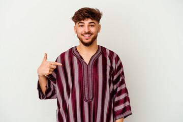 Naklejka premium Young Moroccan man isolated on white background person pointing by hand to a shirt copy space, proud and confident