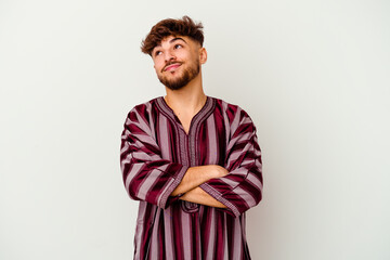 Fototapeta premium Young Moroccan man isolated on white background dreaming of achieving goals and purposes